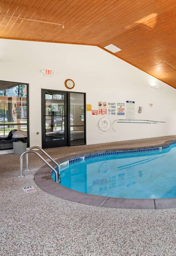 A large indoor swimming pool with a wooden ceiling.