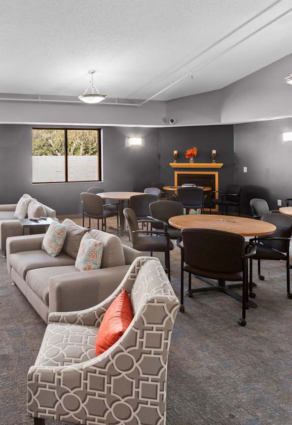A living room with a grey couch and a wooden table.