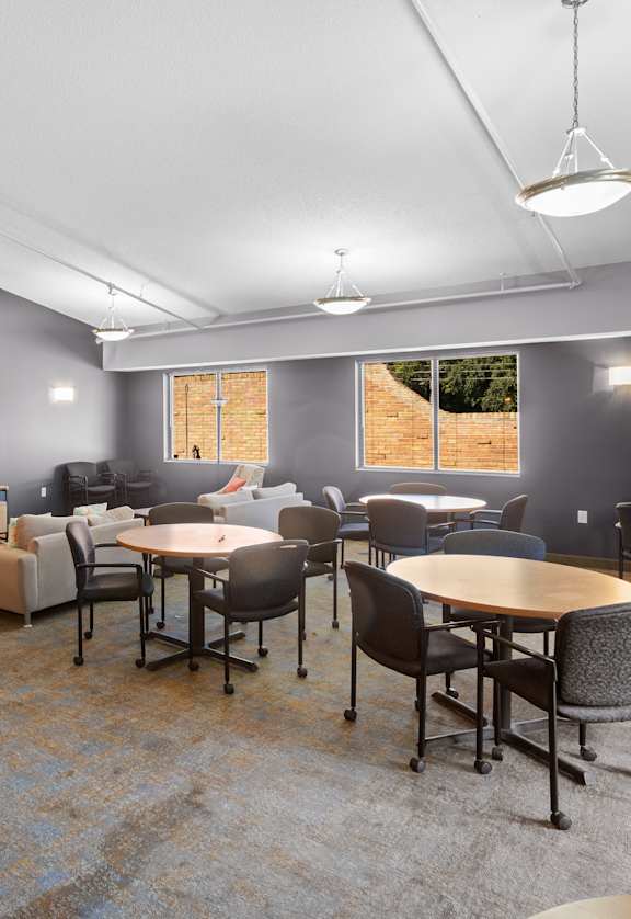 A room with a long table and chairs.