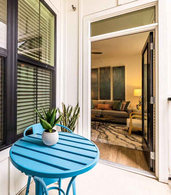 a small patio with a blue table and chairs at The Parker Austin, Pflugerville, 78660