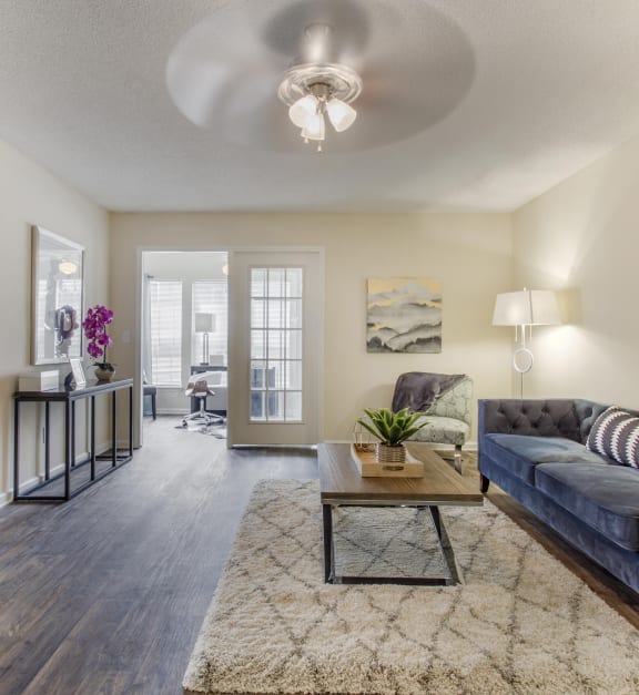 a living room with a couch and a coffee table at Abbington Place Apartments, North Carolina