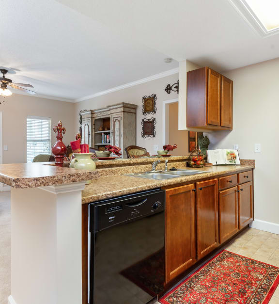 a kitchen with a counter top and a sink at Bedford Parke Apartments in Warner Robins, GA