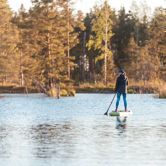 Man standing on boat in the middle of water at The Villas at Sand Lake Resort, Sturgeon Lake