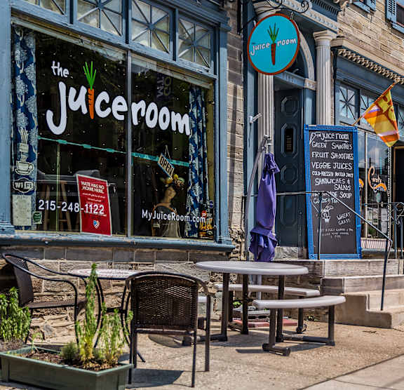 The Juiceroom is a juice bar with a blue sign and a blackboard menu.