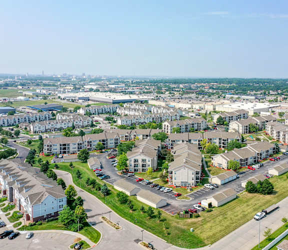 A suburban residential area with houses and parked cars.
