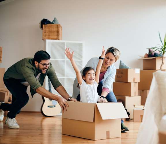 A family is unpacking boxes in their new home.