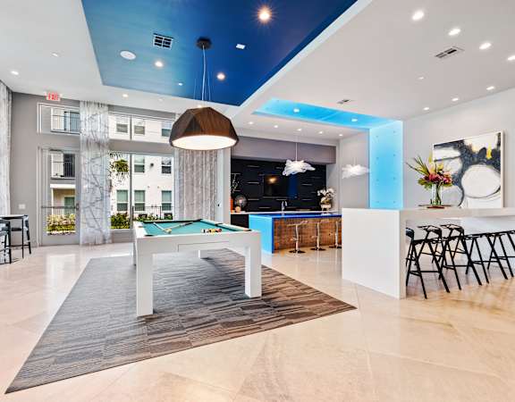 A modern interior with a pool table and bar area.
