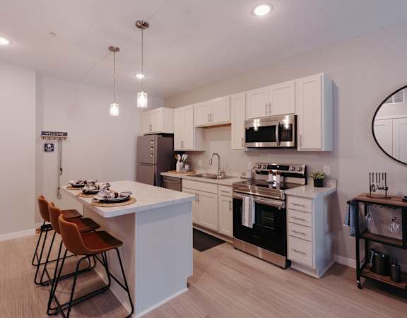 a kitchen with white cabinets and a white counter top and a black and white