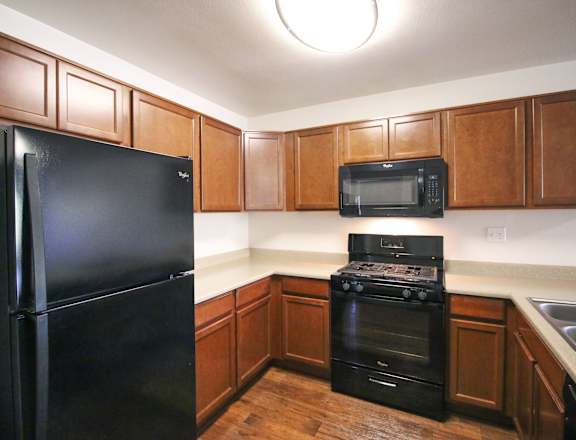Kitchen with Black Appliances at Creekside Villas