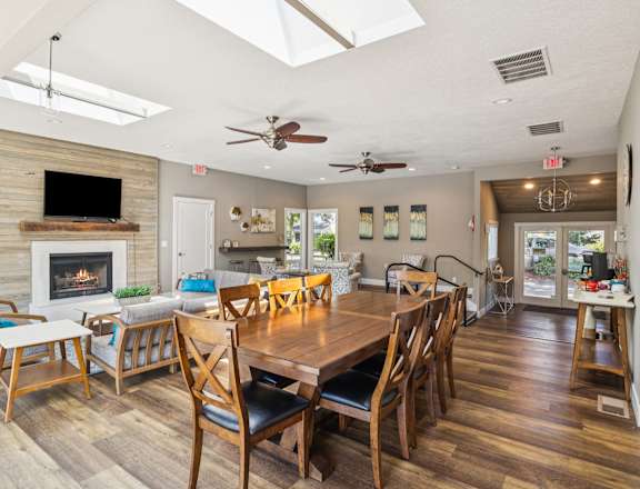 A dining room with a wooden table and chairs.