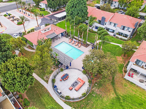 a property with a pool and a house in a neighborhood at The Park Apartments, Rancho Cucamonga, CA