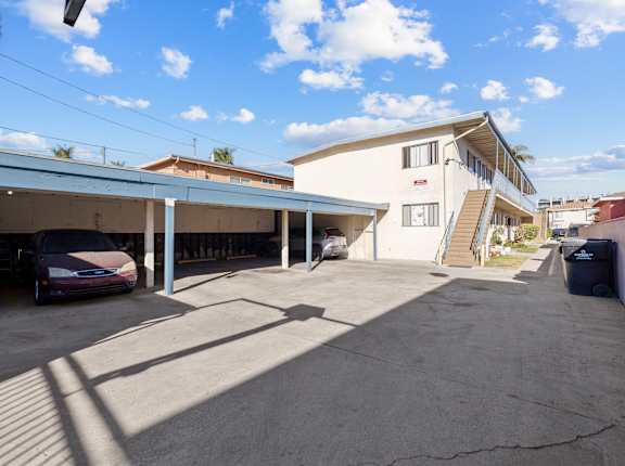 A parking garage with a car parked in front of it.
