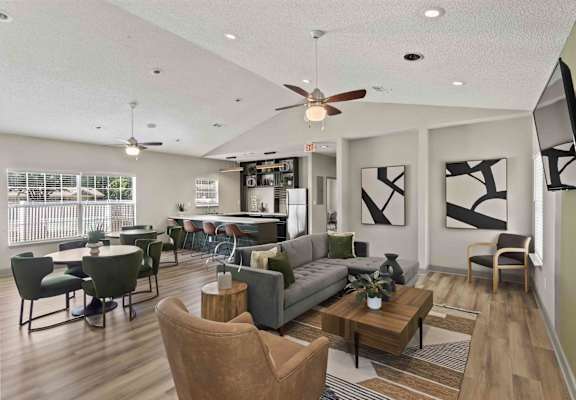 A living room with a couch, chairs, and a coffee table.