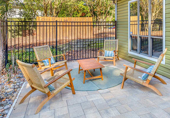 A patio with a table and four chairs.