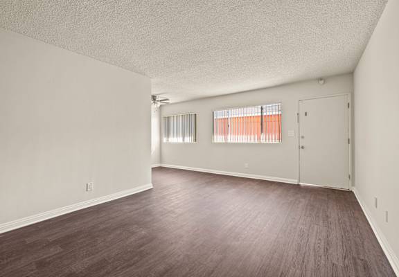 A room with wooden floors and white walls.