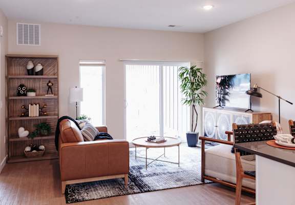 a living room with a couch and a table and a fireplace