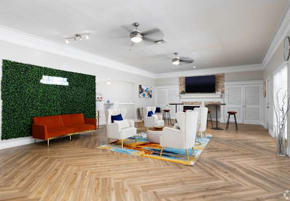a living room with white furniture and a green wall
