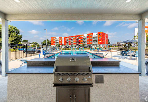the preserve at ballantyne commons clubhouse with a gas grill and pool