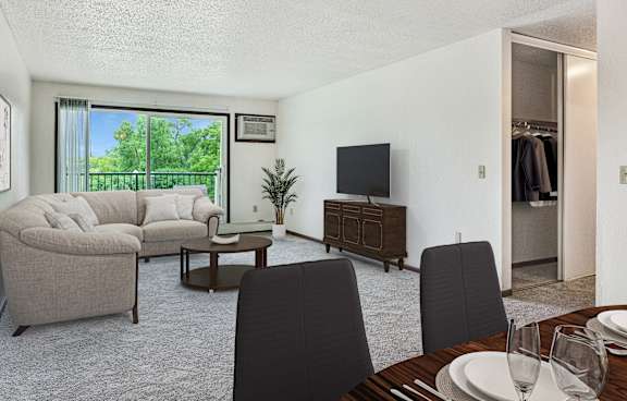 a living room and dining room with a couch and a tv at Pheasant Park Apartments, New Hope, MN, 55428-5401