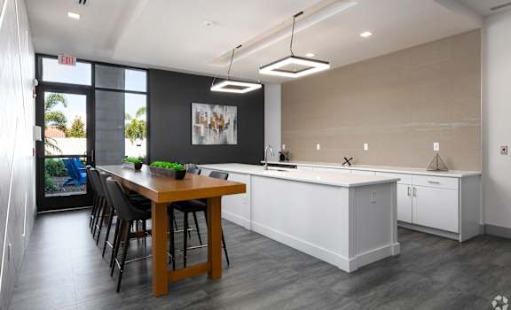 A modern kitchen with a dining table and chairs.