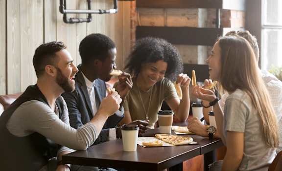 A group of people enjoying a meal together at a table.