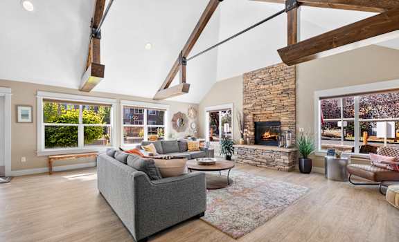 a living room with couches and chairs and a fireplace