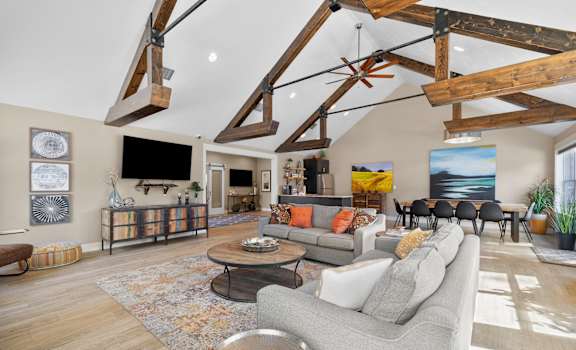 a living room with couches and chairs and a tv