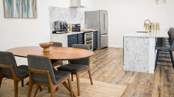 A modern kitchen with a dining table and chairs.