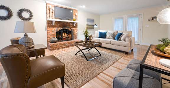 A living room with a fireplace and a couch.