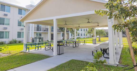 A white building with a covered patio area.