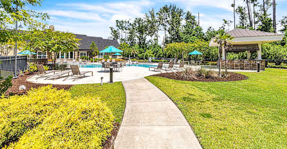 A sunny day at the poolside with a clear blue sky.