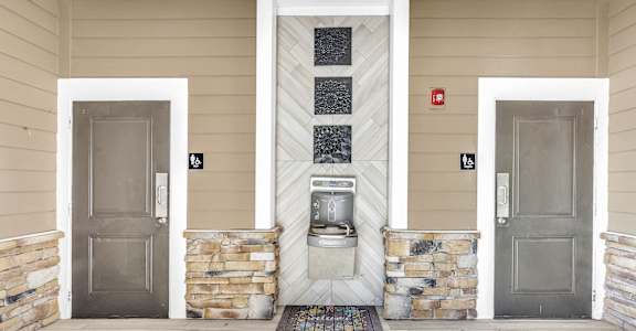 A white door is on the left and a grey door is on the right.