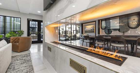 the living room has a fireplace and a seating area with tables and chairs