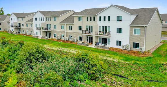 a row of houses on a hillside with grass