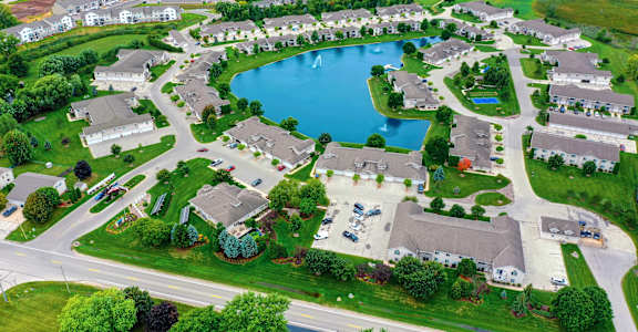 an aerial view of a suburban neighborhood with a large lake