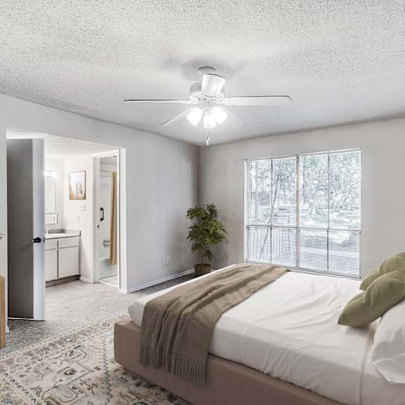 A bed with a grey headboard and white pillows is in the image.