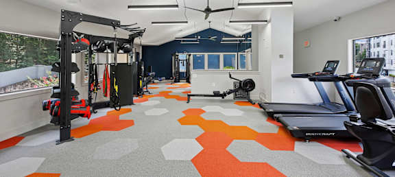 A gym with orange and grey floor tiles.