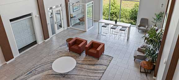 an open living room with a fireplace and a rug