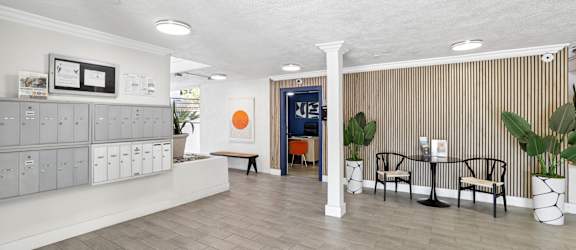 A waiting area with a bench, chairs, and a reception desk.