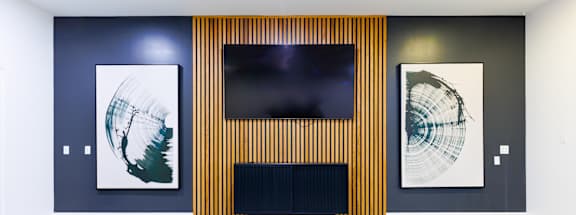 Two green chairs are in front of a television.