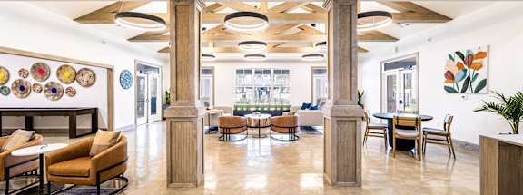 the lobby of a hotel with tables and chairs and a fireplace at The Parker Austin, Pflugerville, 78660