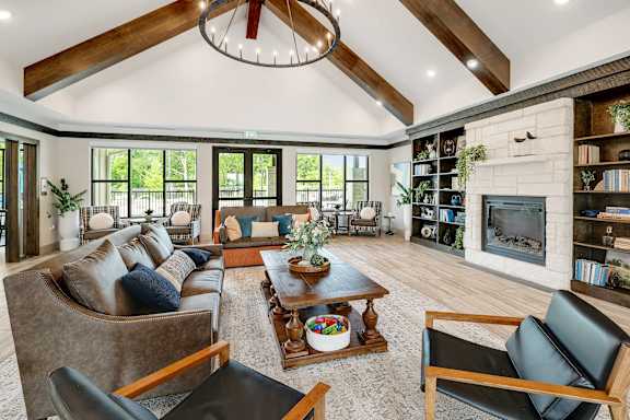 A living room with a fireplace and a large window.
