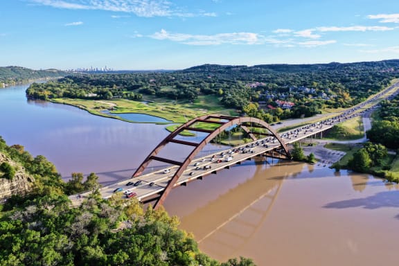 a bridge over a river with cars on it