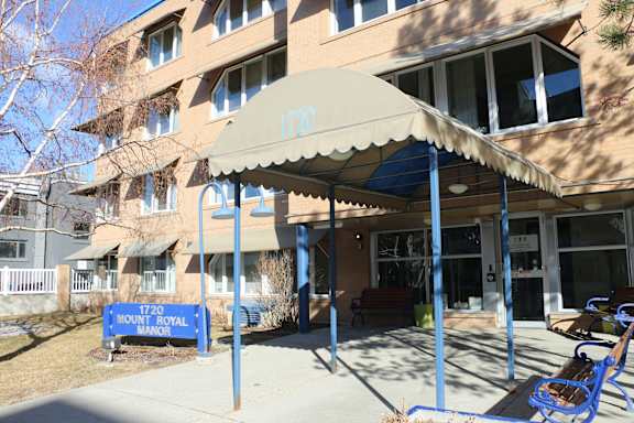 A building with a blue sign that says 1720 Mount Royal.