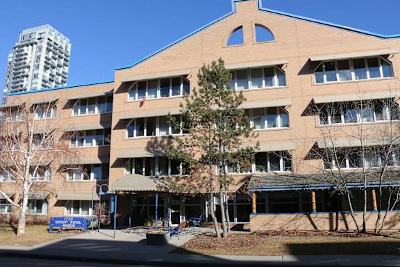 A large building with a blue sign in front of it.