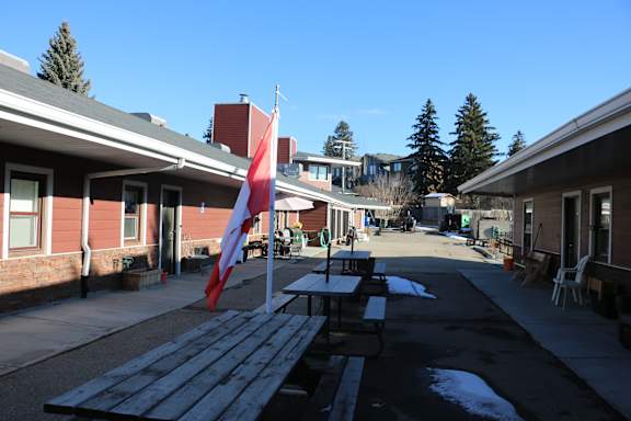 A flag is flying in front of a building.