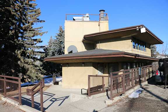 A house with a brown roof and a balcony with a railing.