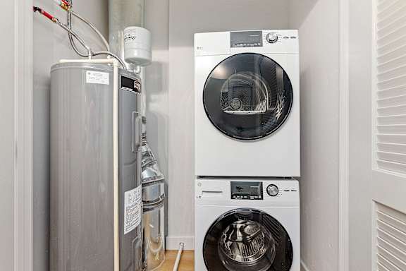 A washing machine and a water heater in a small room.