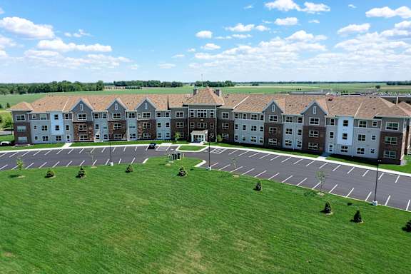 A large building with a parking lot in front of it.