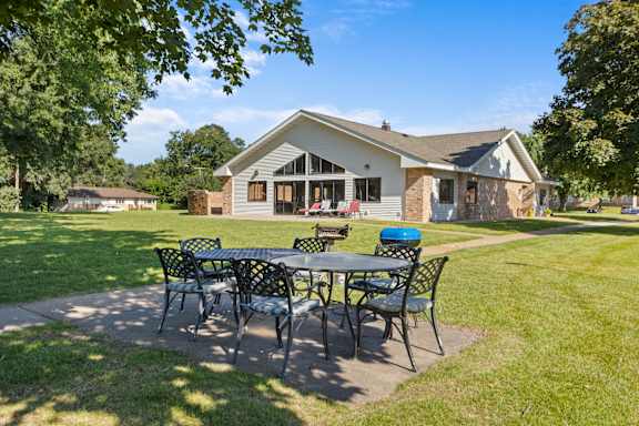 A house with a patio and a table set for four.